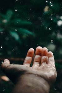 Close-up of hand on water