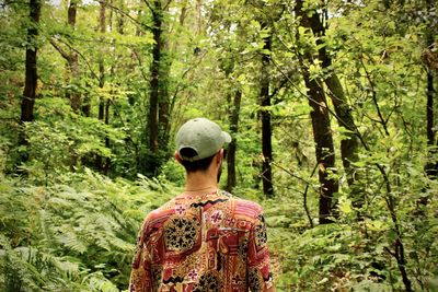 Rear view of man standing in forest