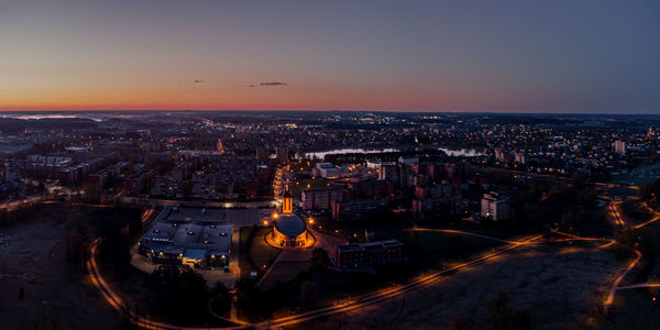 High angle view of city lit up at night