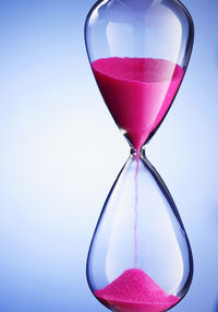 Close-up of clock against glass wall