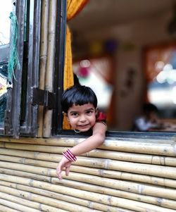 Portrait of cute girl leaning on window