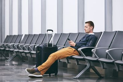 Man sitting on chair at airport