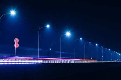 Light trails on illuminated street lights at night