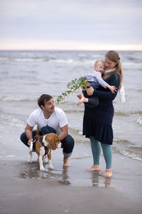 Full length of happy family at beach