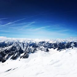 Snow covered mountain against blue sky