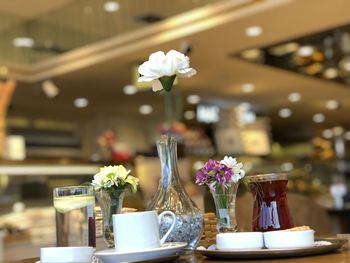 Close-up of flower vase on table in restaurant