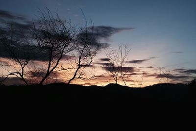 Silhouette landscape against sky during sunset