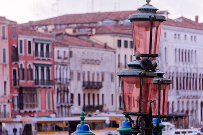 Close-up of street light against buildings in town