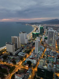 High angle view of buildings by sea against sky