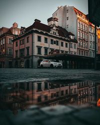 Buildings by canal in city