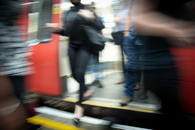 Blurred motion of people walking on street
