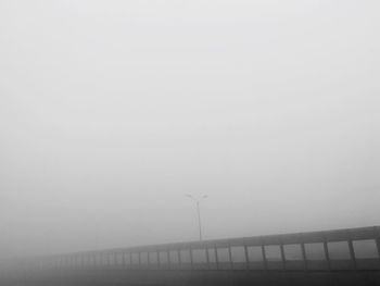 Traditional windmill against sky during foggy weather