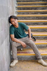 Young man sitting on steps
