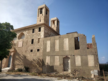 Low angle view of old building against sky