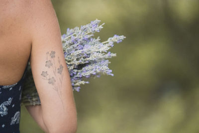 Girl with lavander and botanical tattoo 