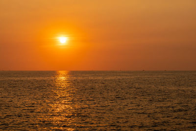 Scenic view of sea against orange sky during sunset