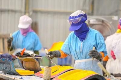 Close-up of people working in factory