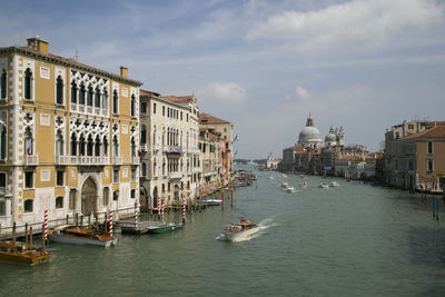 Buildings by canal in city