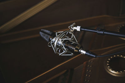 Close-up of microphone by piano at recording studio