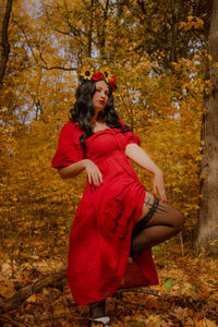 Portrait of young woman standing in forest