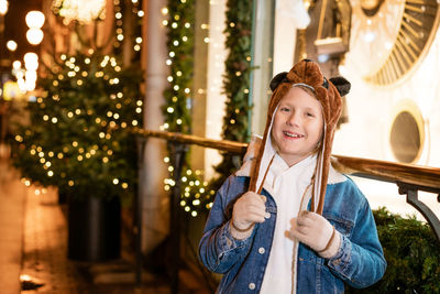 Happy young boy wearing a new year bear hat with a thrilled christmas mood.