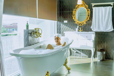 Portrait of smiling young woman in bathroom