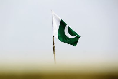 Low angle view of flag against sky