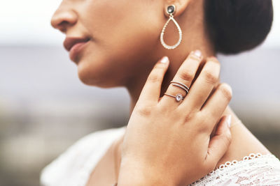 Midsection of woman wearing jewelry