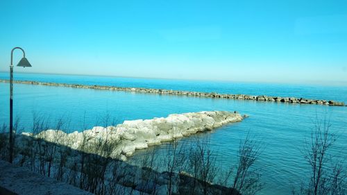 Panoramic view of sea against clear blue sky