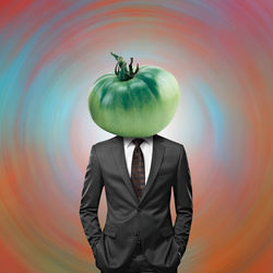Midsection of businessman holding apple
