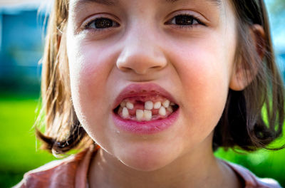 Close-up portrait of cute girl with gap tooth