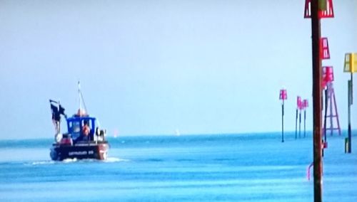 Lifeguard ship in water against sky