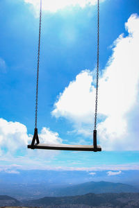 Low angle view of swing against sky