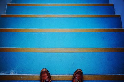 Low section of person on blue steps