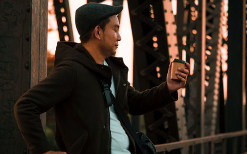 Midsection of man using mobile phone