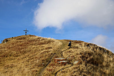 Man on arid landscape against sky