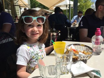 Girl sitting on table at restaurant