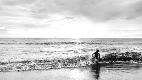 Scenic view of sea against cloudy sky