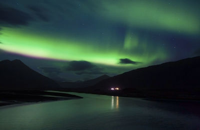 Scenic view of lake against sky at night