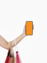Woman using smart phone against white background