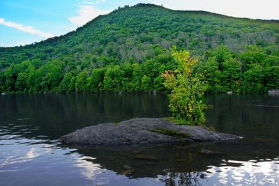 Scenic view of lake and mountains against sky