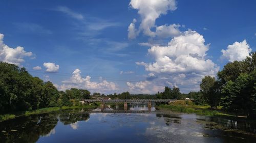 Scenic view of lake by building against sky