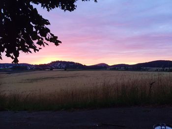 Scenic view of field against sky during sunset