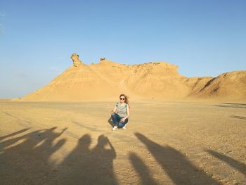 Full length of man on arid landscape against clear sky