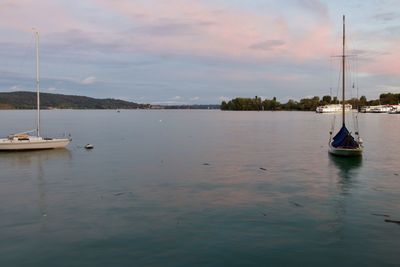 Sailboats in sea against sky