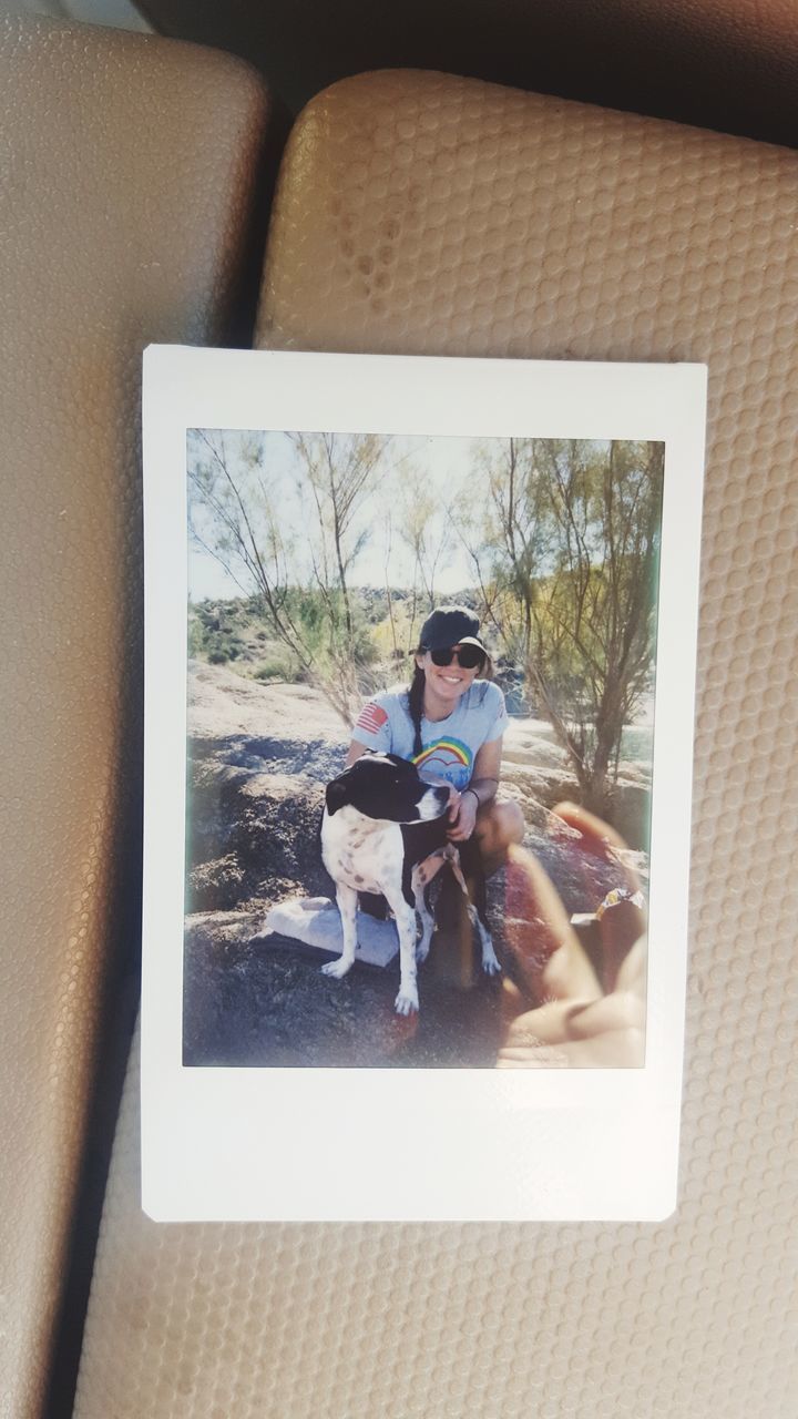 WOMAN SITTING WITH DOG AT HOME