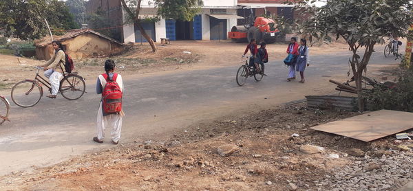 People riding bicycle on road