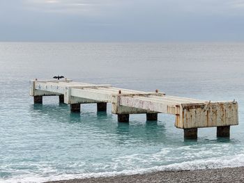 View of pier on sea against sky