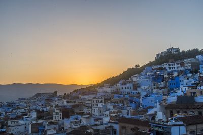 Cityscape against clear sky during sunset