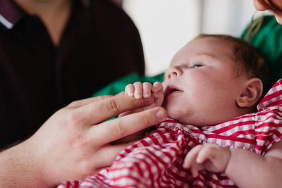 Cropped image of baby girl in parents hands